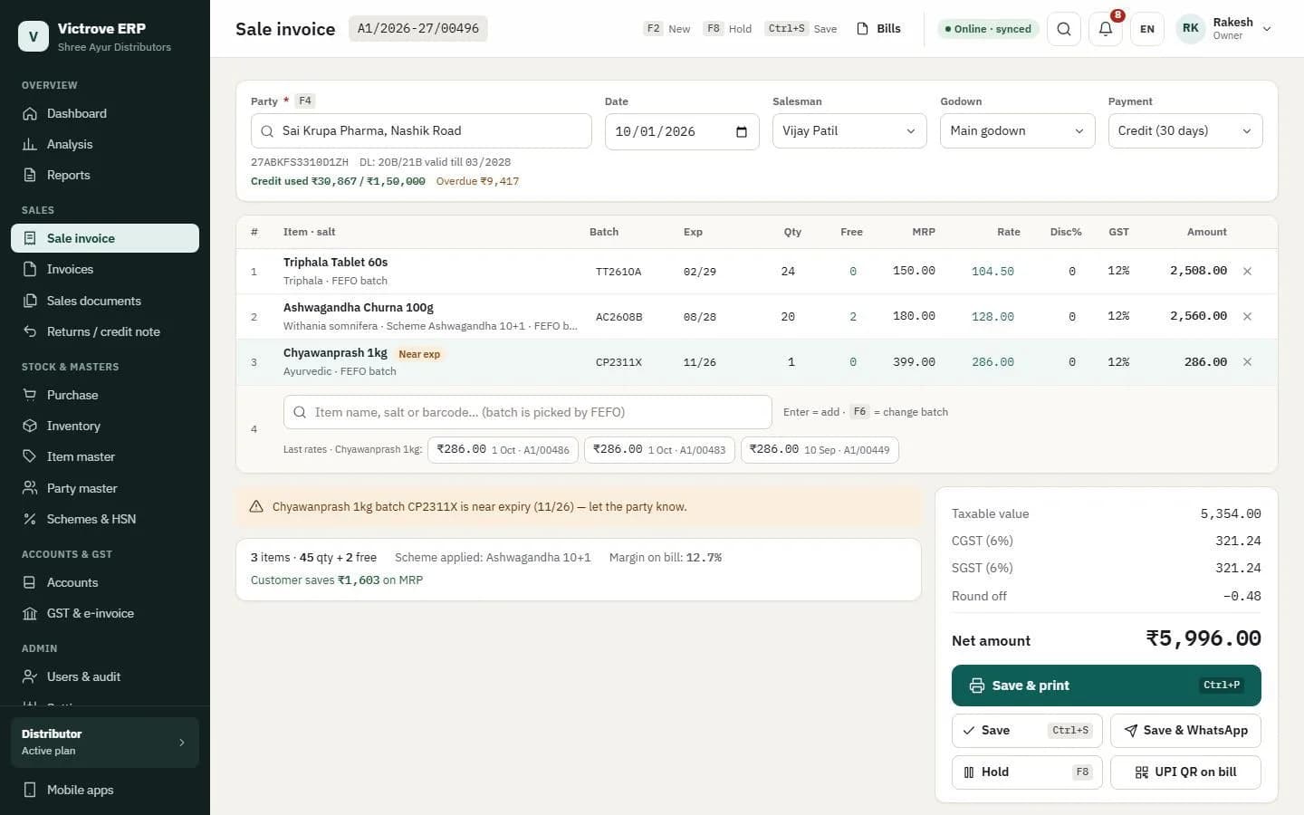 Sale invoice with FEFO batches, a 10+1 scheme, a near-expiry warning and live GST totals